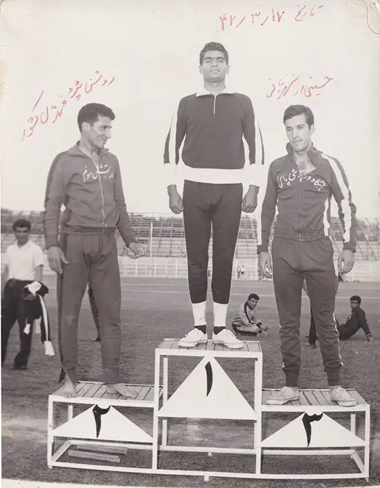 Manouchehr Shamshiri winning first place in track and field at the Iranian Army National Championships in 1968, second place Roshan Pajouh one of the country's track and field record holders and third place Hosseini from the police force